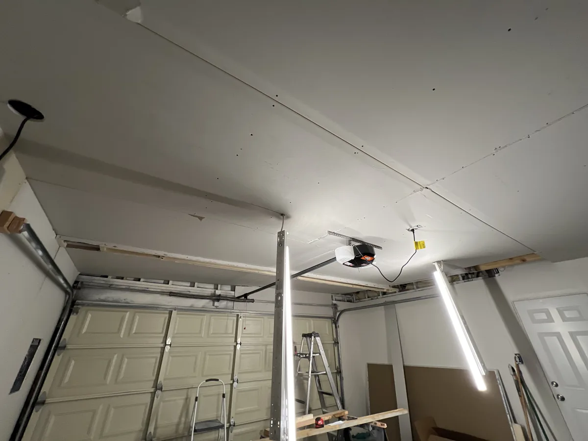 garage ceiling with new drywall hung and taped, ready for texture and paint