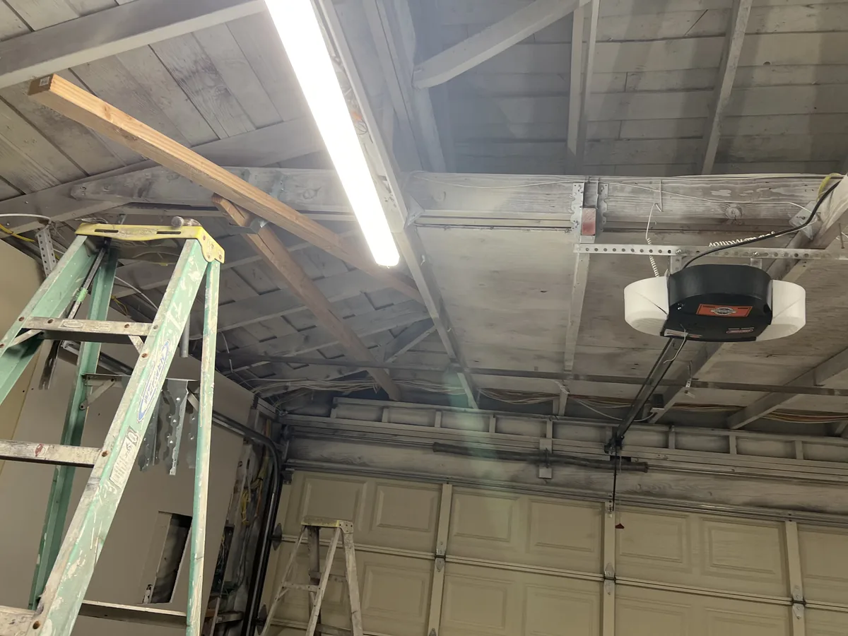 garage ceiling with exposed rafters before new drywall