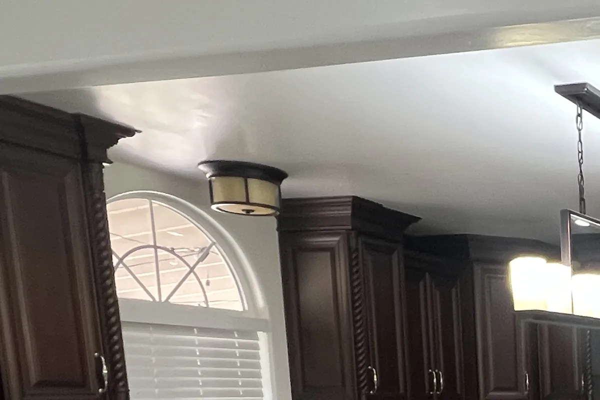 Kitchen walls and ceiling repainted around stained cabinets, a Tony's Painting job in San Diego County